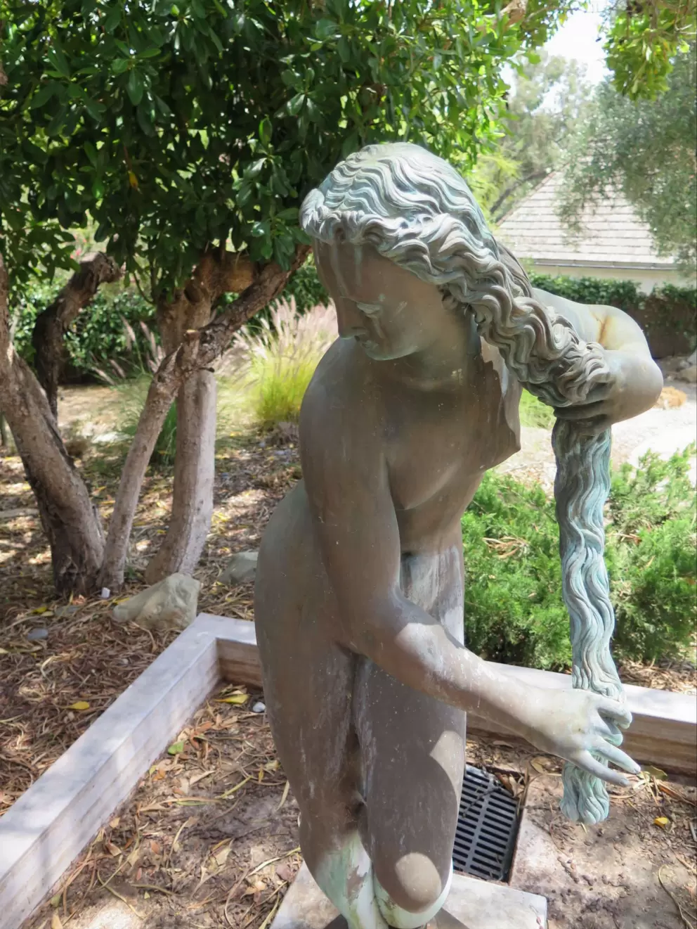 Statue of woman with long hair.