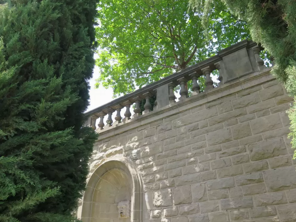 Fountain, wall, and trees.