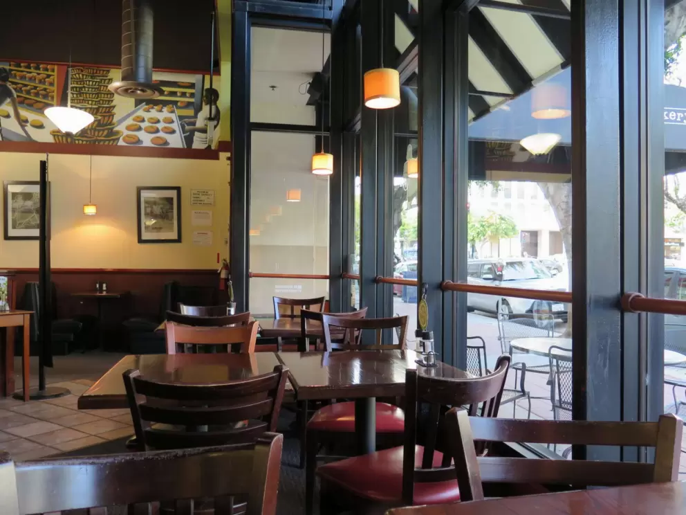 Inside Corner Bakery Cafe, with its big windows and attractive decor.