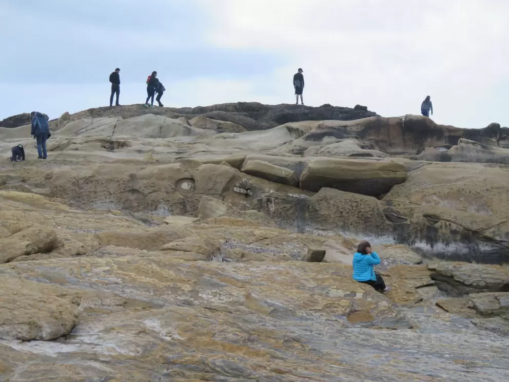 Climbing on the rocks by the ocean.
