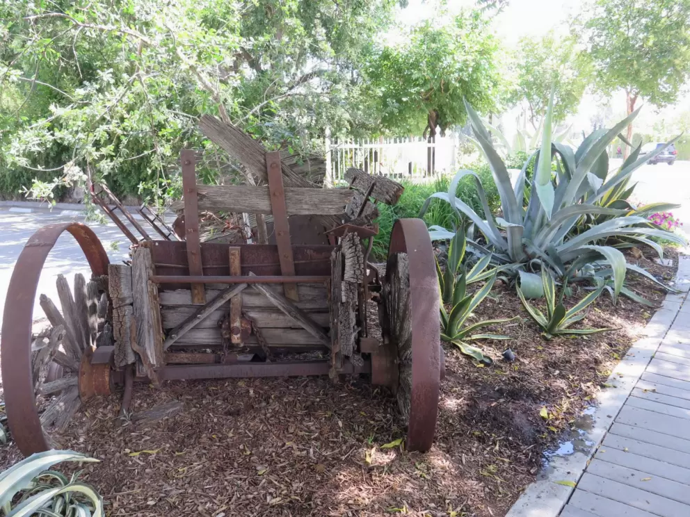 Old wagon beside the sidewalk.