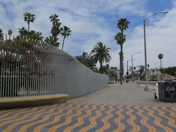 Stripey sidewalk at the entrance to the park.