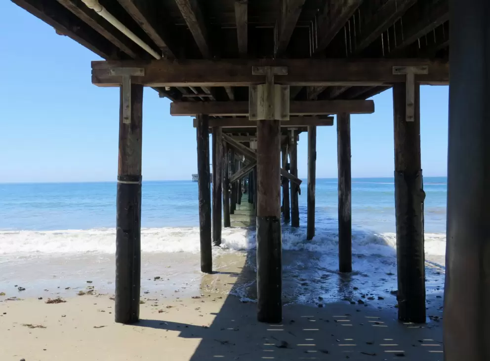 Under the pier.