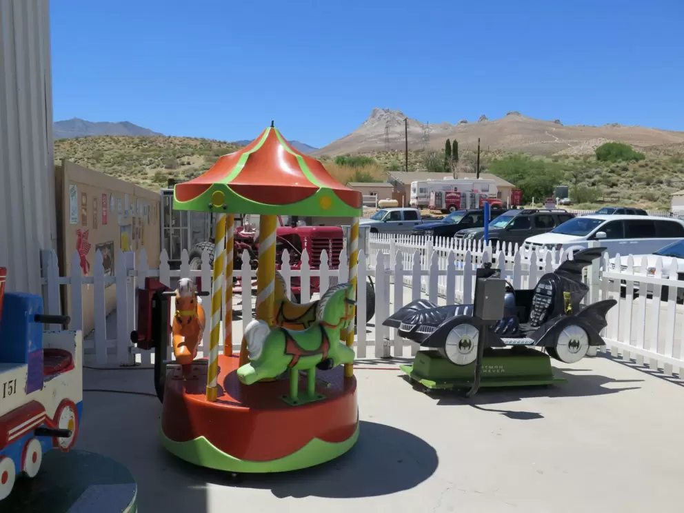 Kids can play on a batman car, mini-carousel, and train.