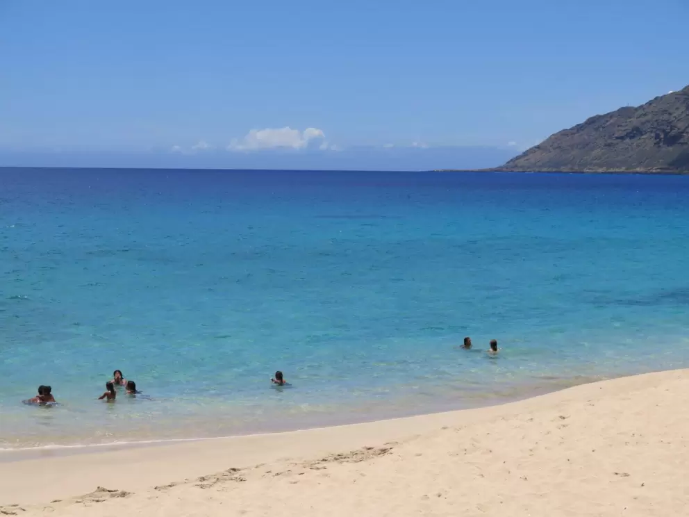 Kids swimming on the south end of Makua Beach. Notice the amazing colors of the water.
