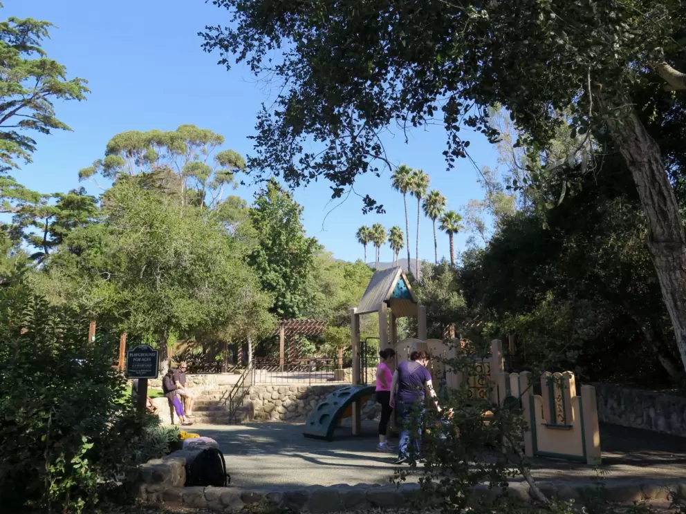 Parents and toddlers at the playground.