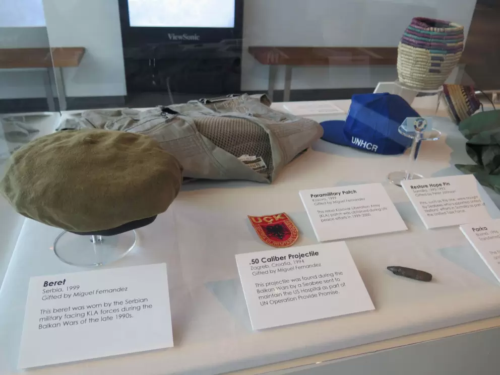 Beret worn by the Serbian military facing Kosovar-Liberation Army forces, and paramilitary patch of the KLA.