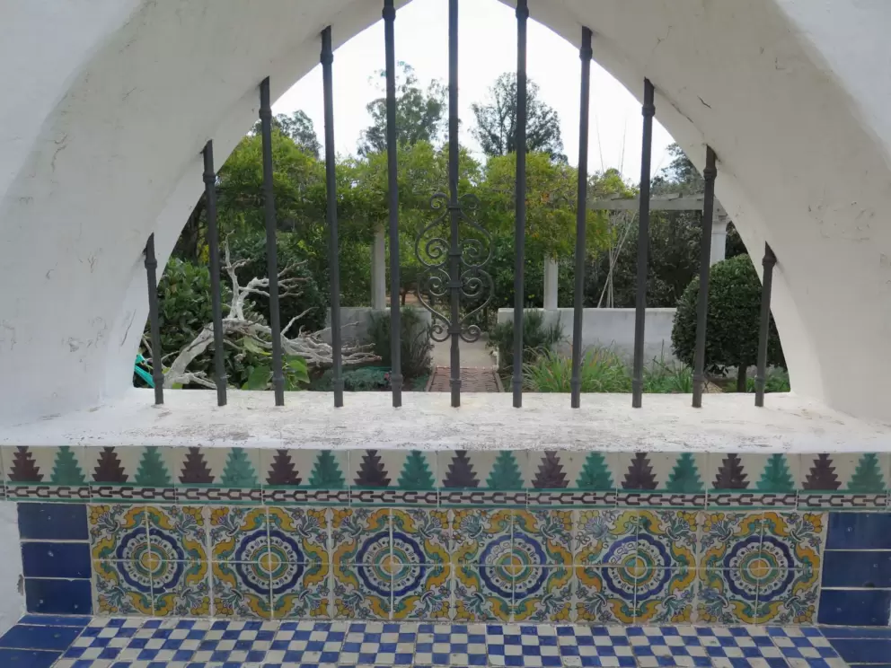 Looking past a tilework seat to the herb garden.