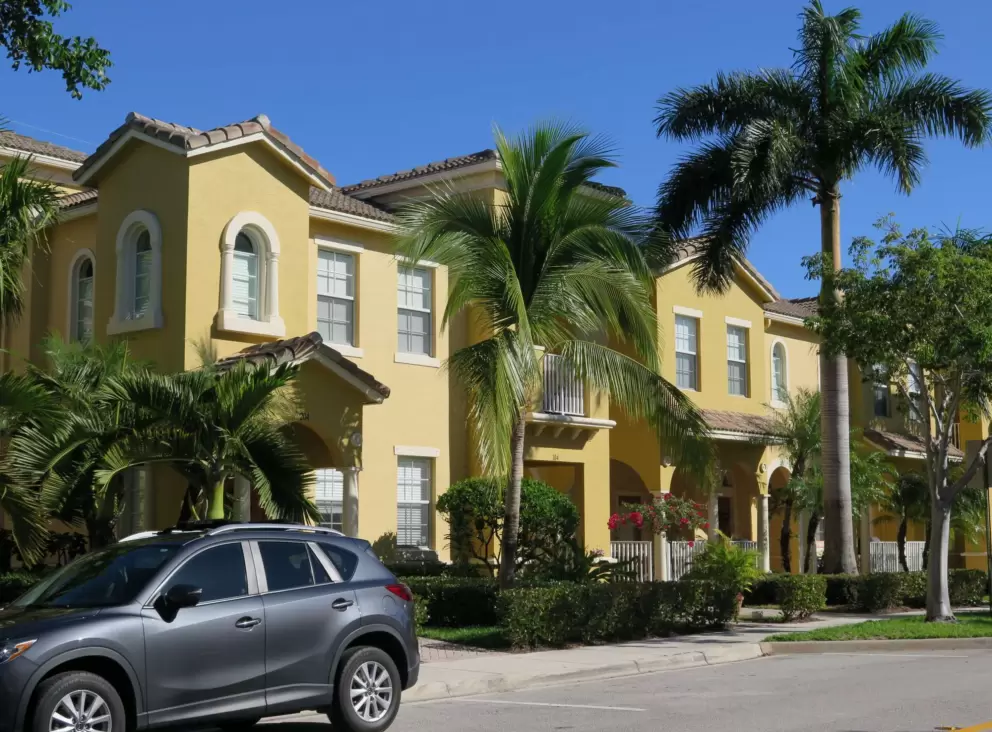 Arched windows on orange townhouses in the Botanica development.