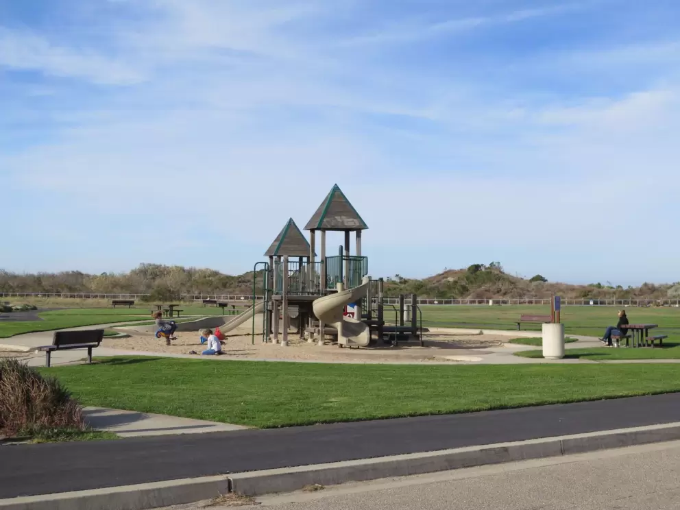 The bike path goes past the playground.