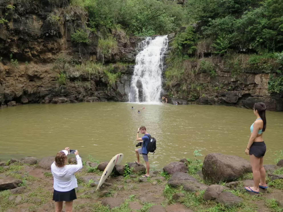 Standing beside the waterfall.