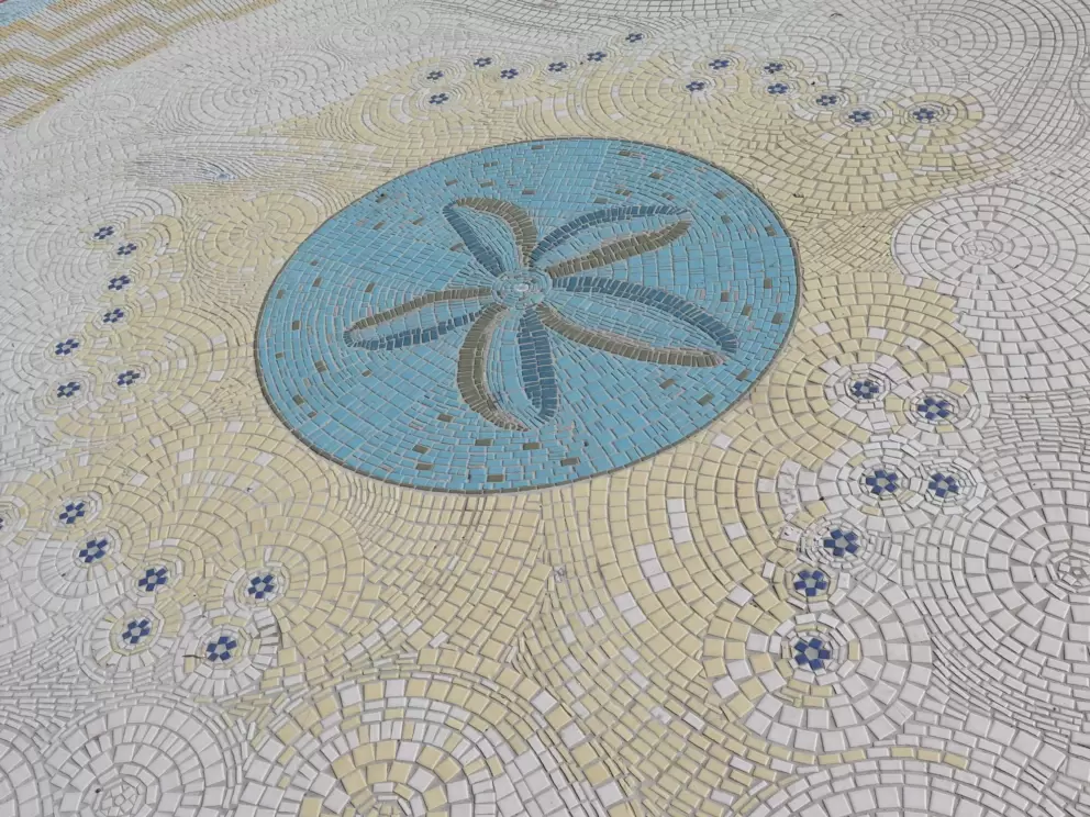 Starfish design in the tiles on the sidewalk along Cabrillo Blvd. 