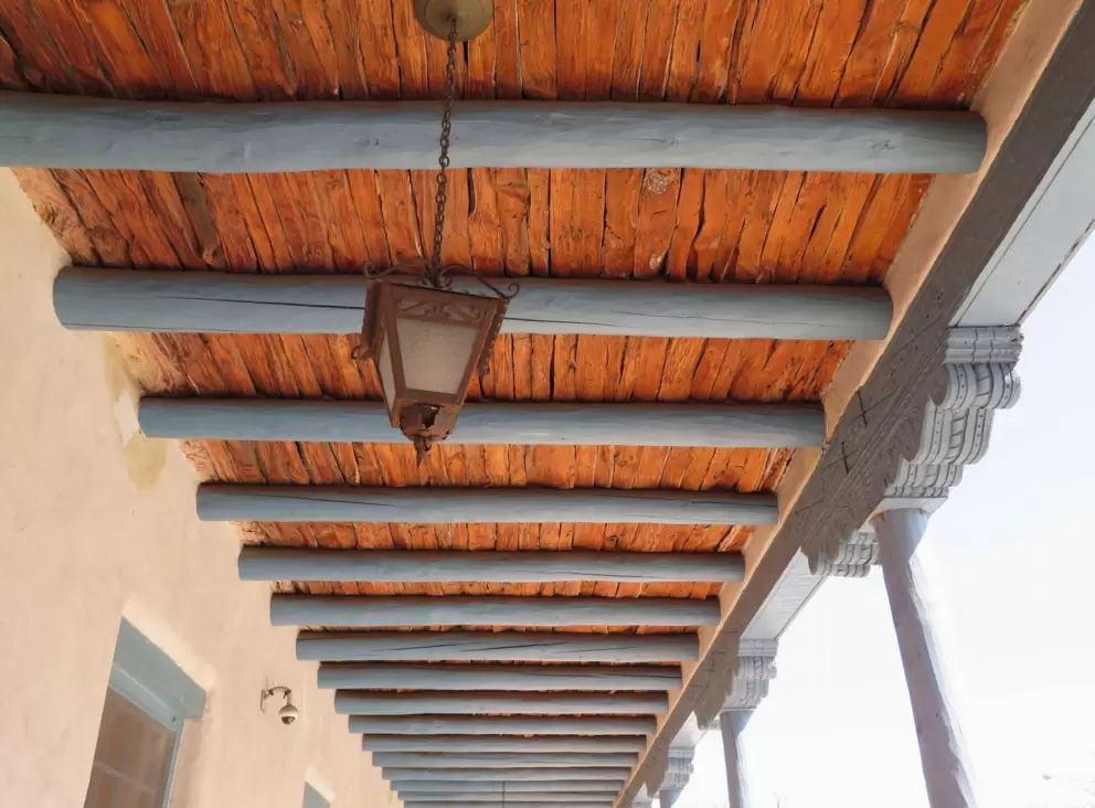 Turquoise-painted logs in the ceiling. 