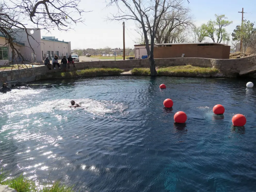 Swimming in the blue hole and hanging out on the wall.