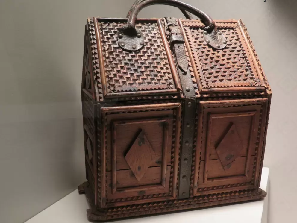Tramp art satchel from France, made of wood, leather, and metal.