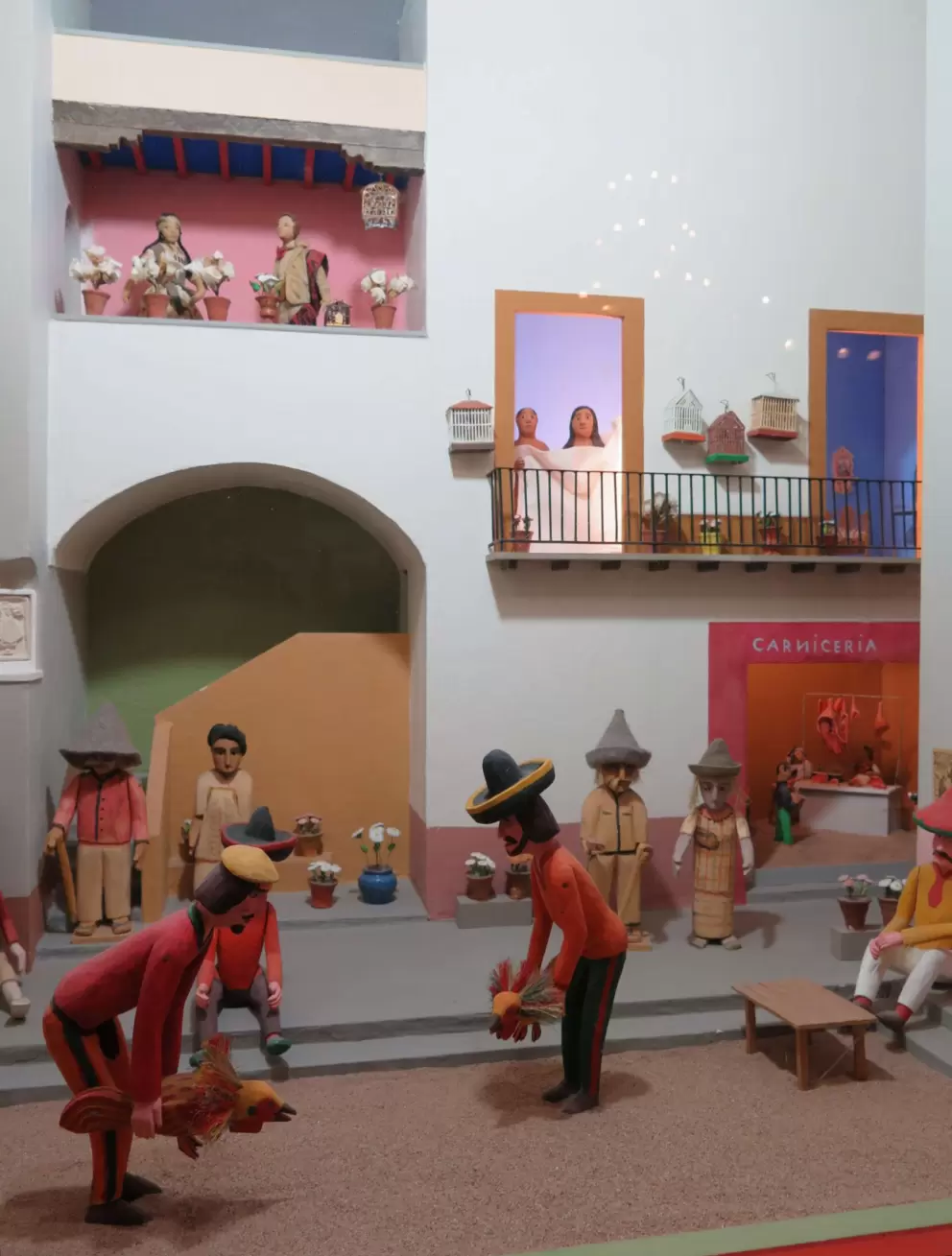 Cute Mexican street scene- notice the couple in the upstairs doorway, woken by the noise!