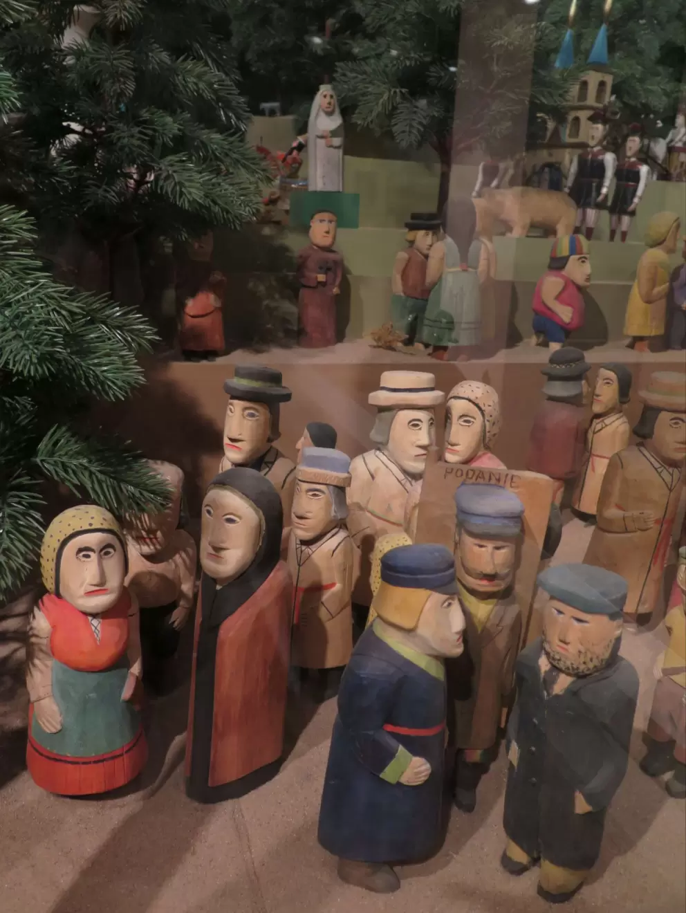 Diorama of people gathered.