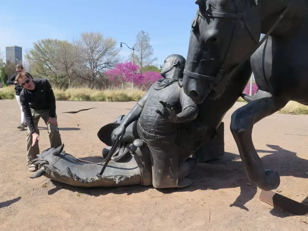 A tourist checks out the dramatic Centennial Land Run Sculpture.