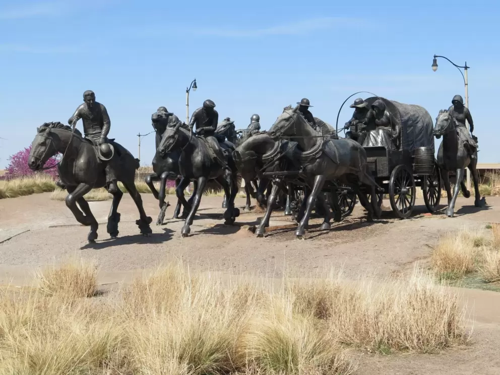 The Centennial Land Run Sculpture and dry grasses.