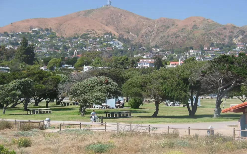Bike path, picnic area, and hilly backdrop, at San Buenaventura Beach Park. 