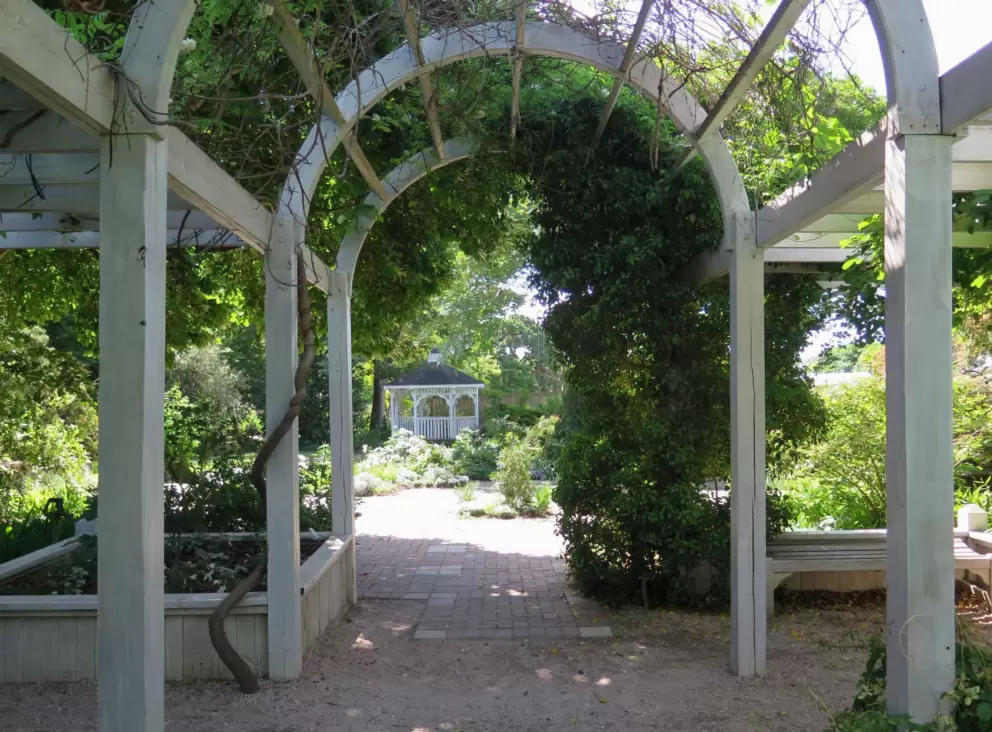 Looking through an arbor toward the gazebo.