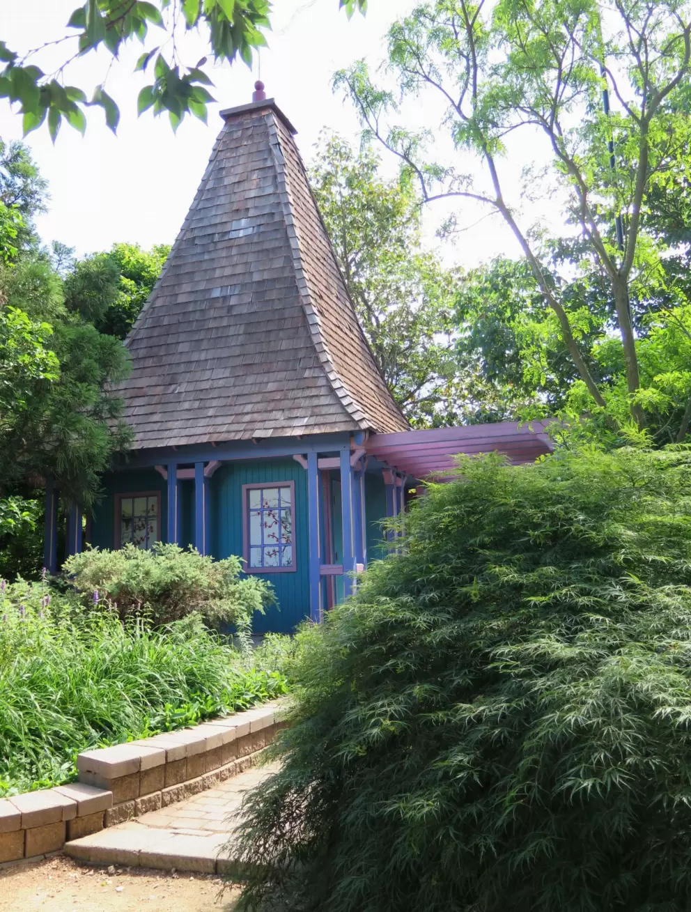 Little blue building with steep roof.