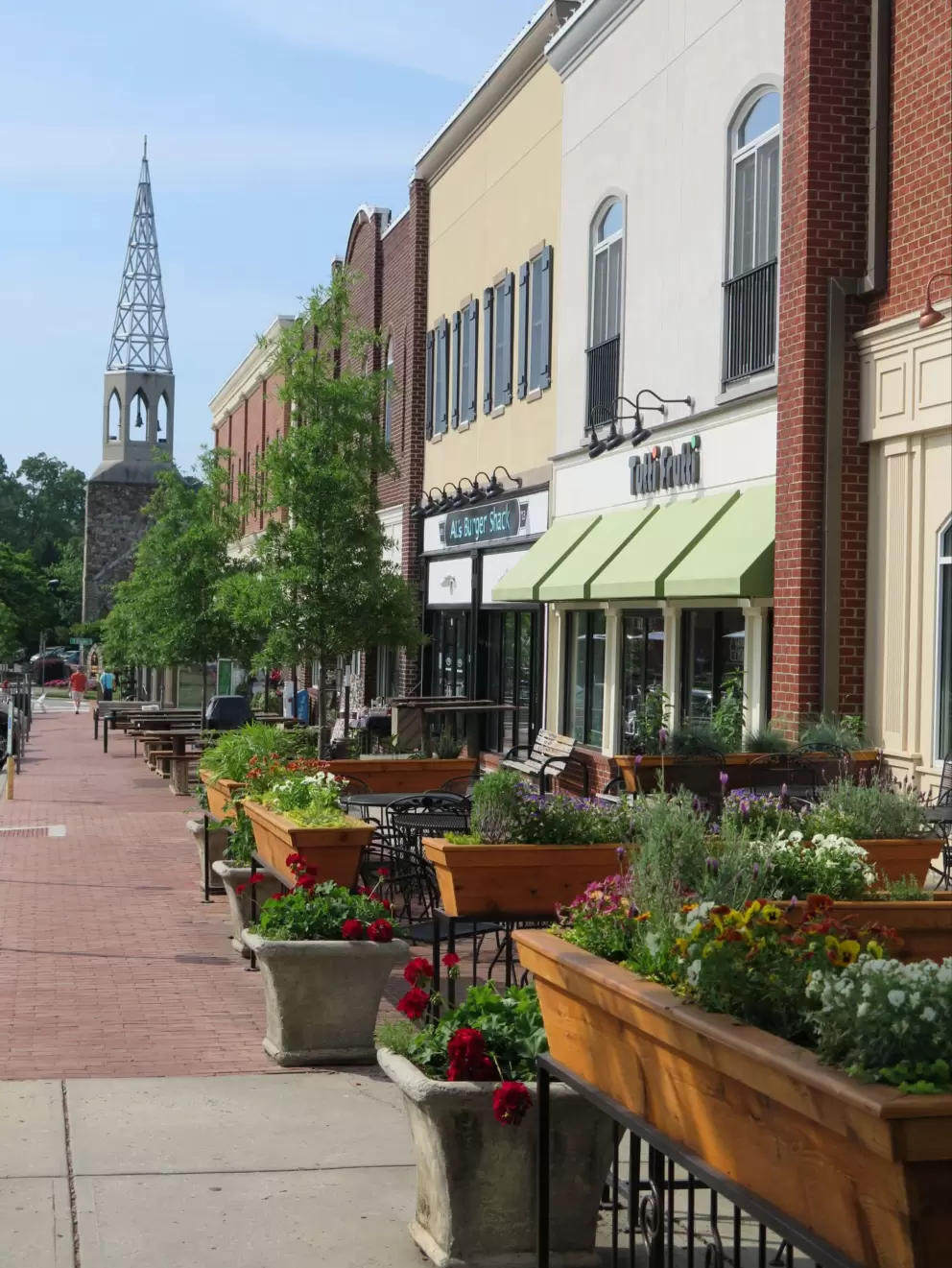 Sweet view looking past the restaurants and flower boxes to the church steeple.