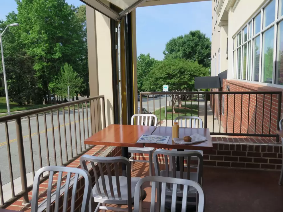 Side seating on the balcony at Weaver Street Market, with view of the church.