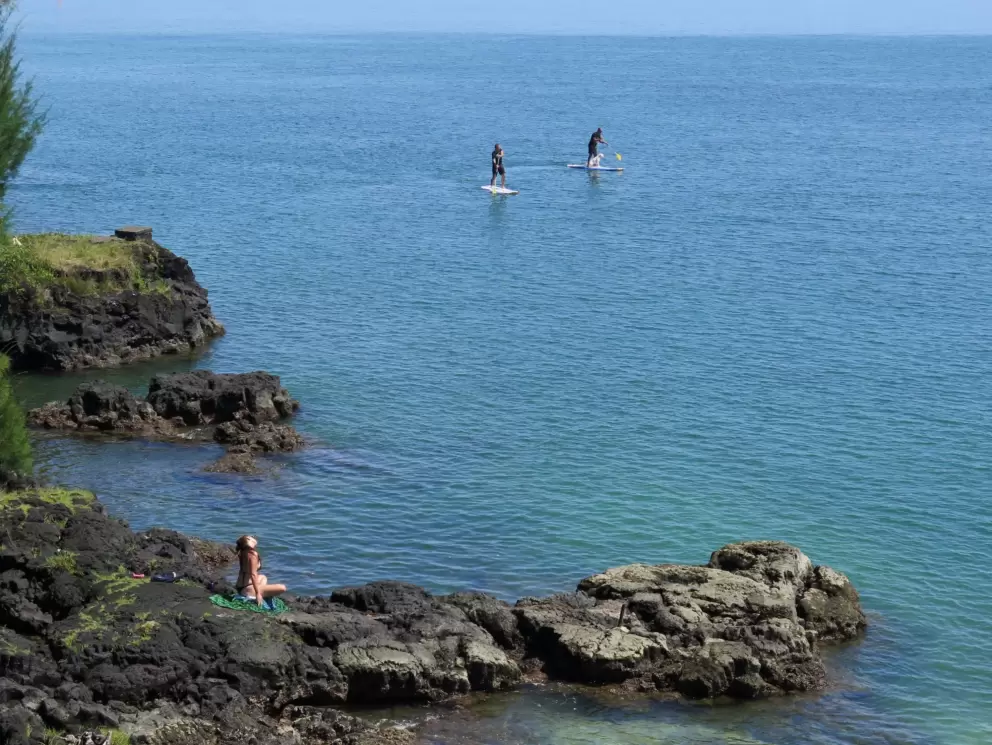 Sitting on the rocks to the west of Reed's Bay Beach Park.