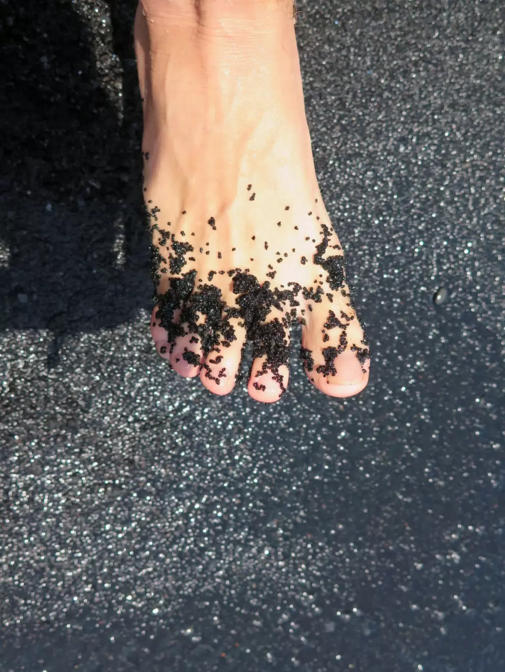 Black sand on your toes!