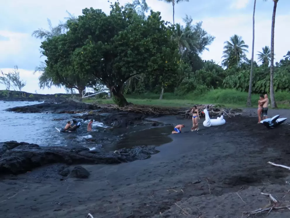 Black sand beach at night, with fun floaties!
