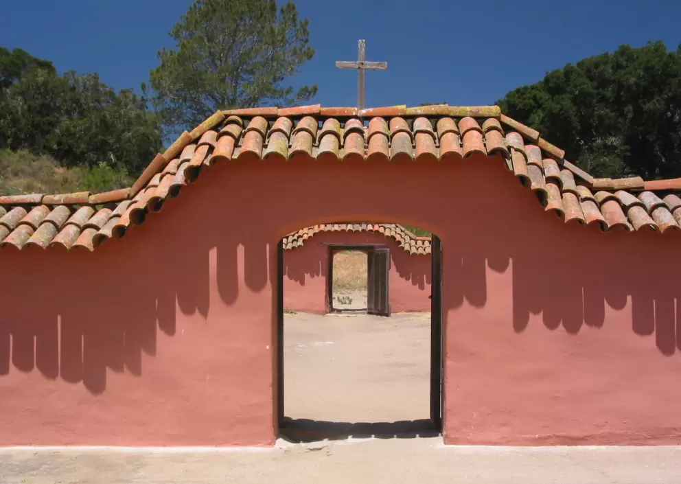 Salmon pink walls against blue sky.