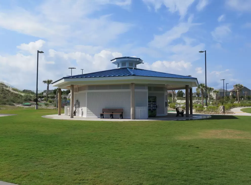 Pavilion, lawn, and blue sky.