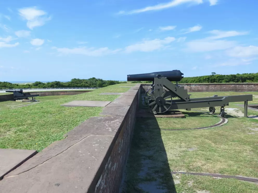 Two cannons facing out toward the beach.