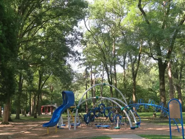 The space age playground in the shade of many trees.