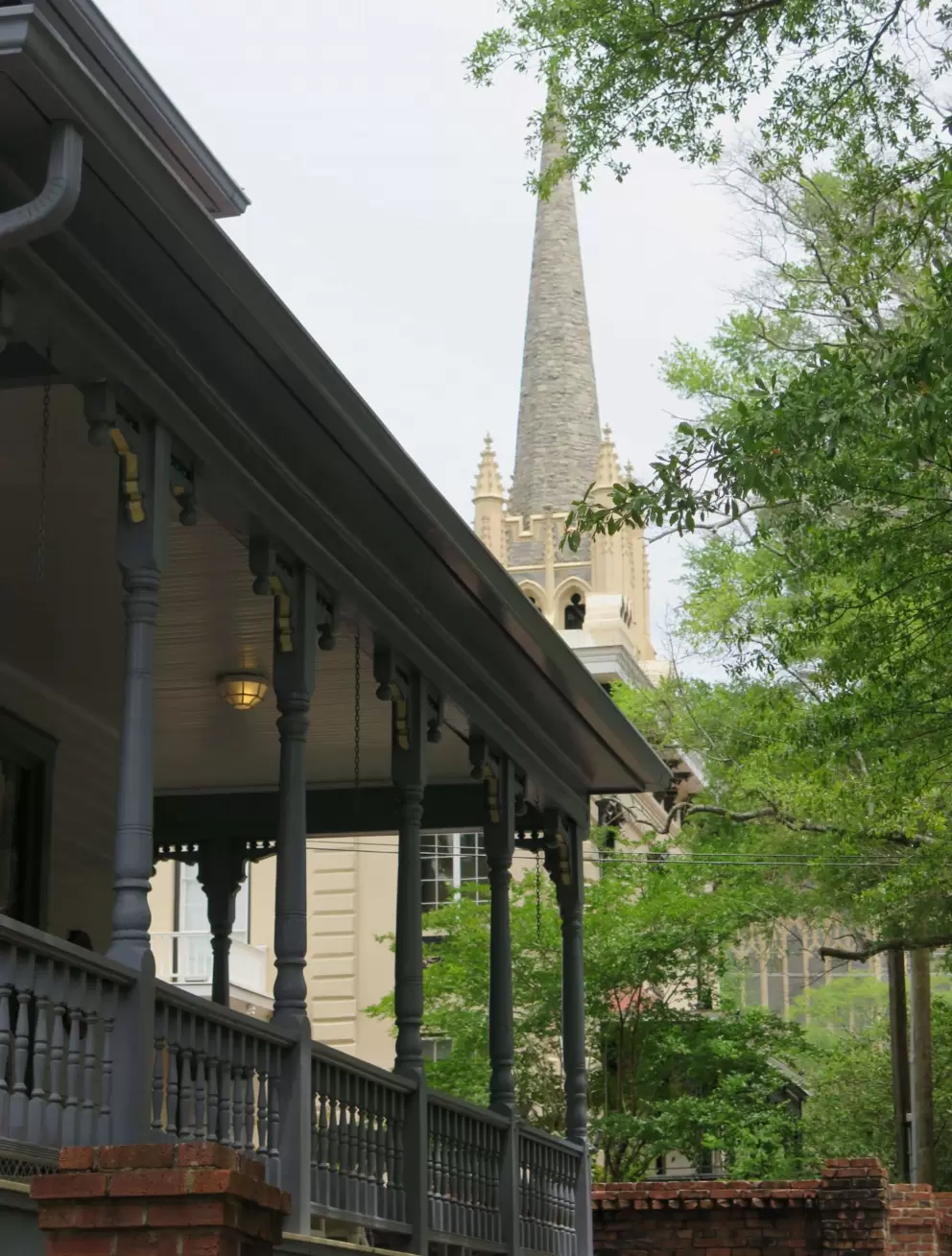 Beautiful southern porch with church in distance.