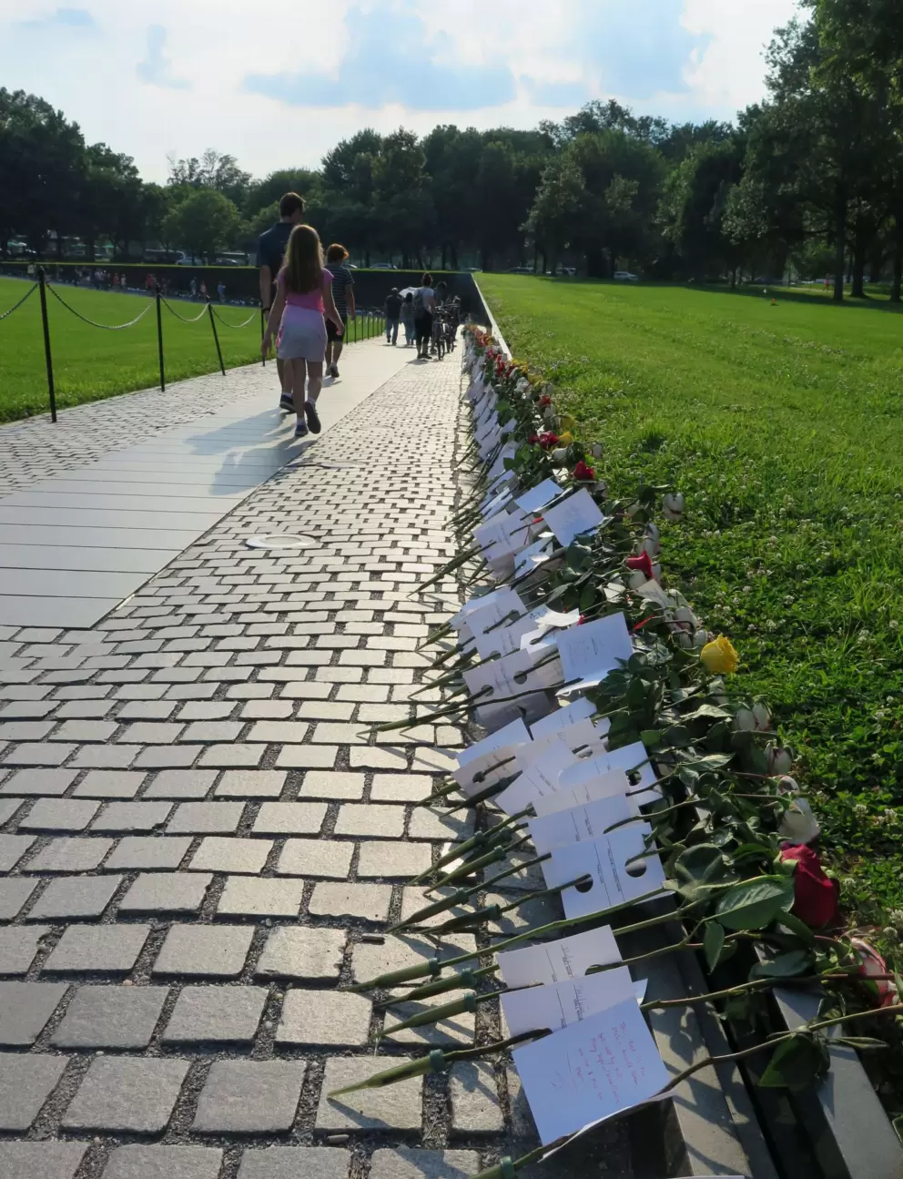 Roses left at the entrance to the wall.