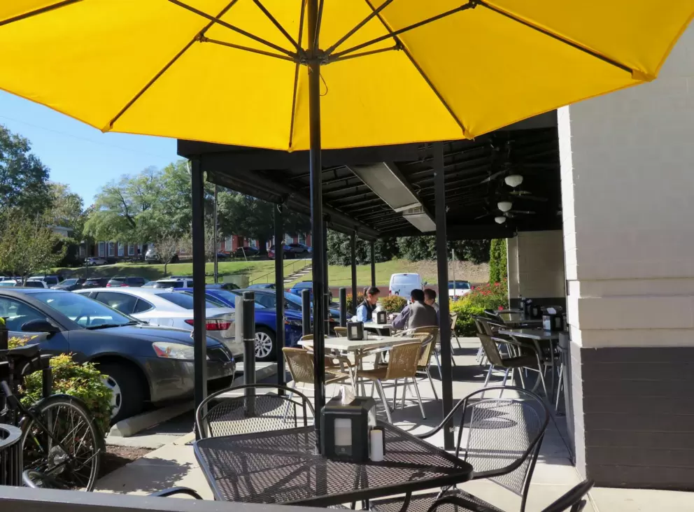 Yellow umbrella outside at Alpaca Peruvian Charcoal Chicken.
