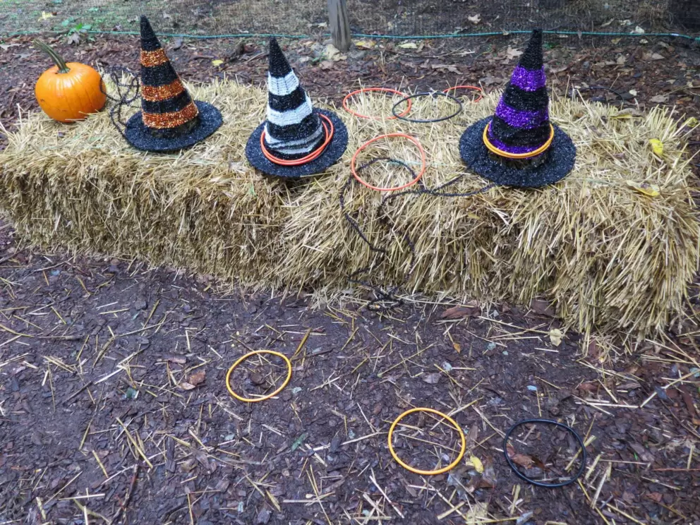 Throw the hoops over the witches hats.