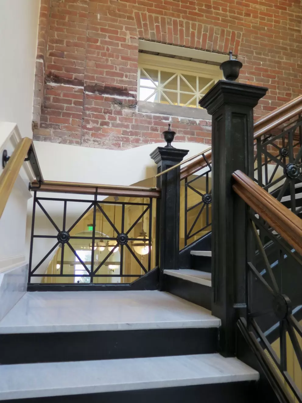 Cute staircase and brick wall leading up to the third floor.