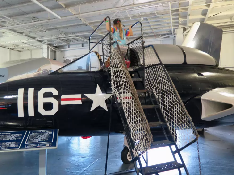 A child climbs into an airplane.