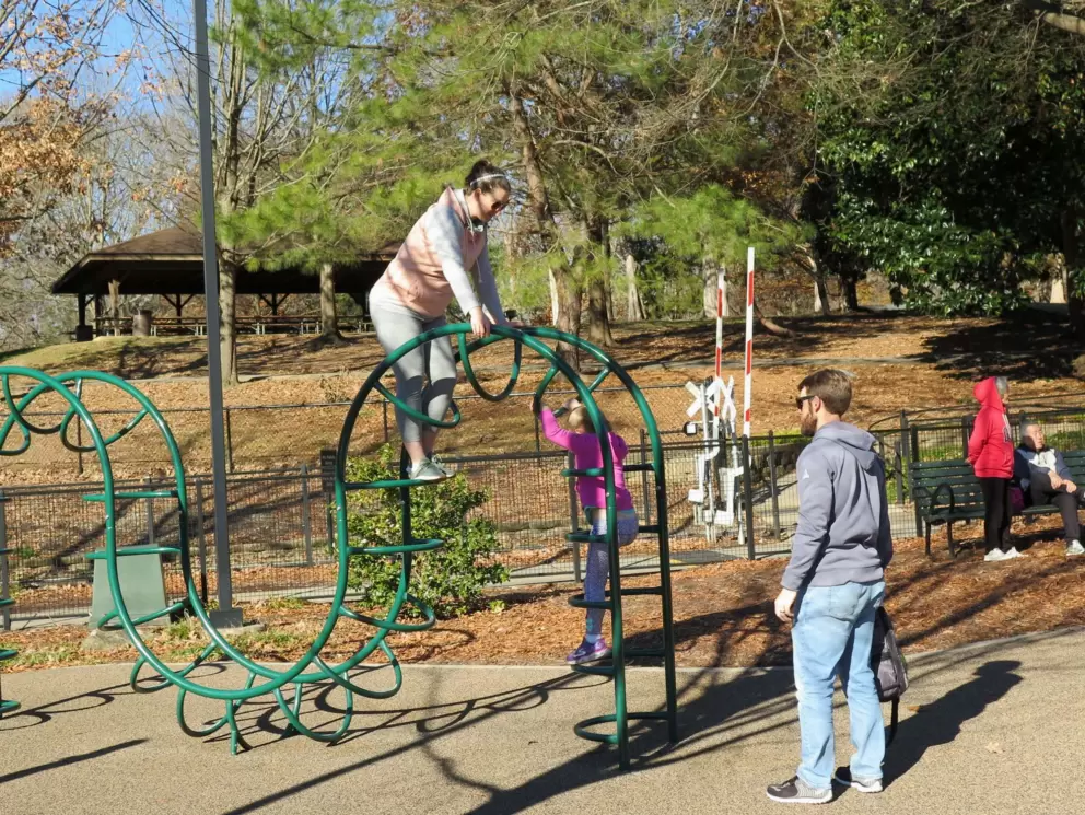 A mom climbs with her child.