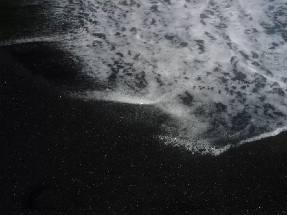 White foam on black sand!