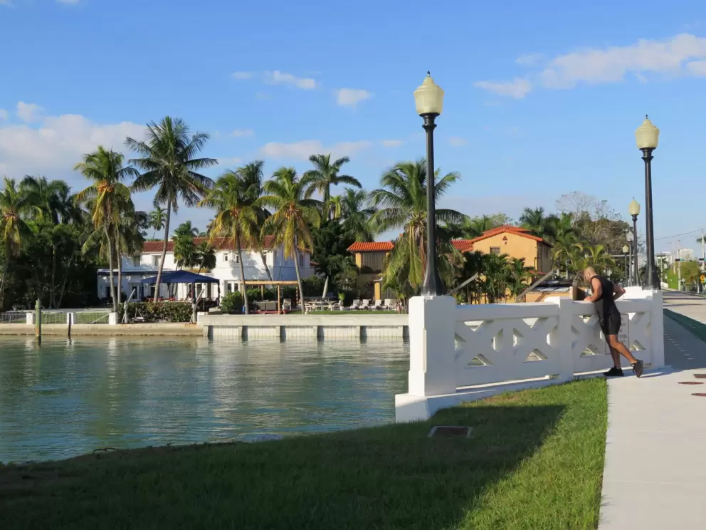 A jogger takes a break to look at the water.