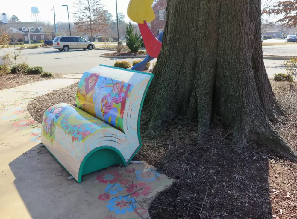 Wizard of Oz bench by a tree.