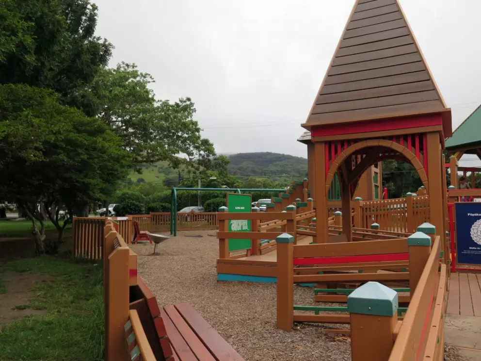 The green mountains behind the playground.