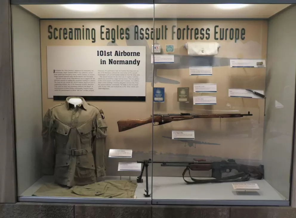 Uniform, rifle, and French and German phrase books, of the 101st Airborne division who went to Normandy.