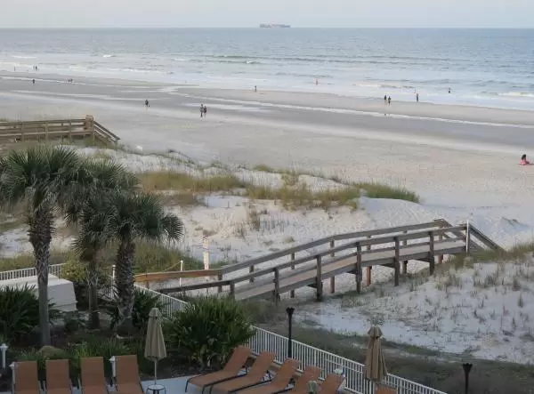 Wooden boardwalk with steps down to the beach.