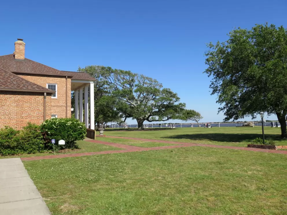 Park in front of Fort Johnston building.
