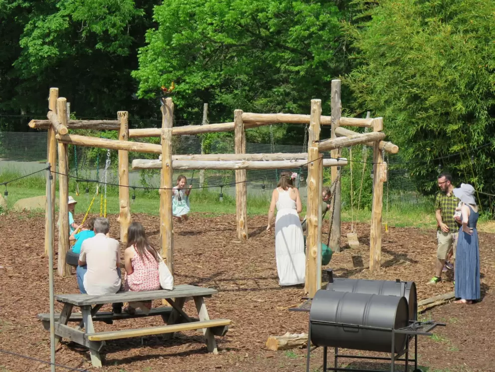 Parents gather around the swings.